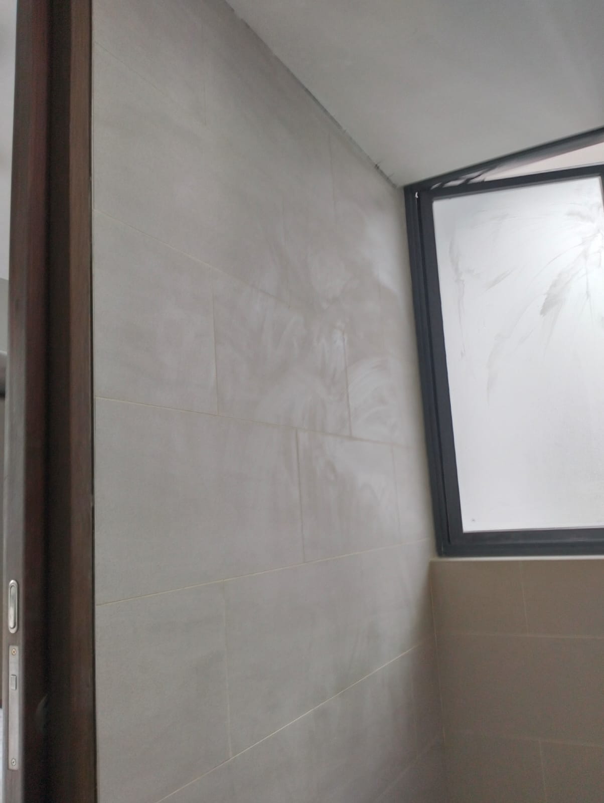 After: New large-format wall tiles installed in condo bathroom