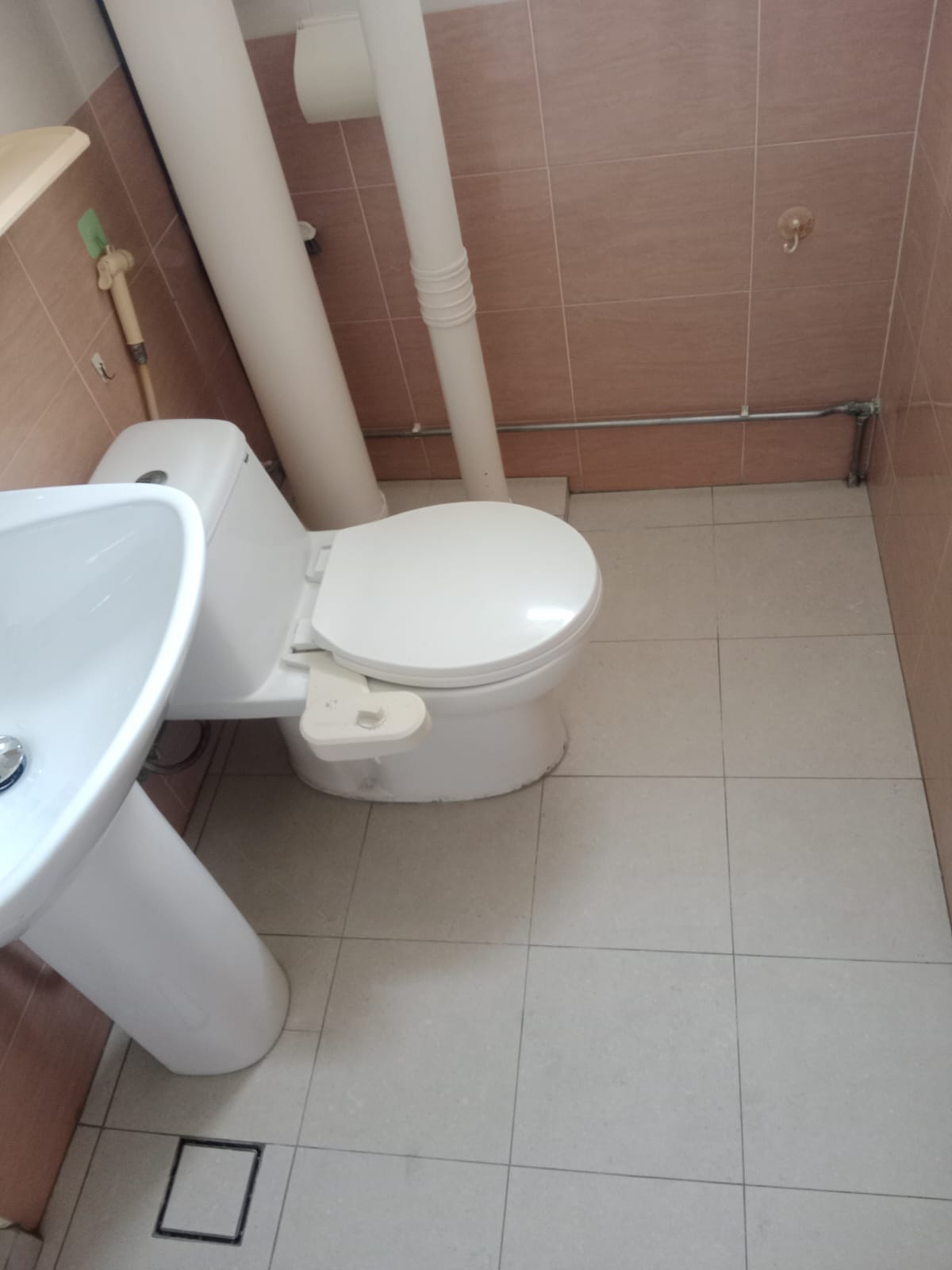 After: New floor tiles, toilet, and basin installed in HDB bathroom