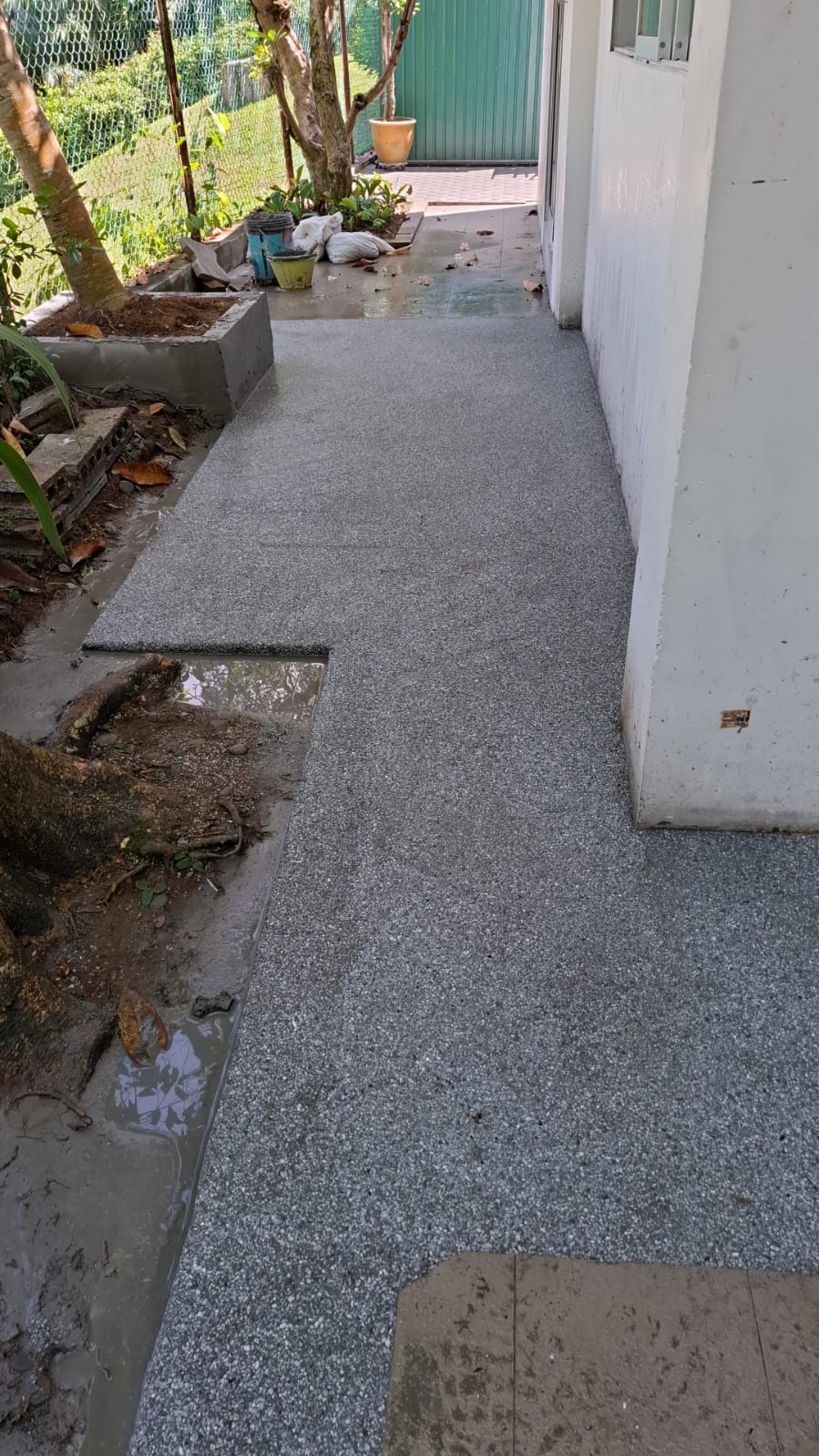 After: Seamless pebble epoxy coating applied over outdoor pathway at landed property